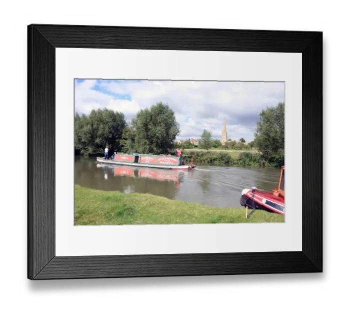 Framed Print : Lechlade. A canal boat on the upper Thames near St Lawrences Church at