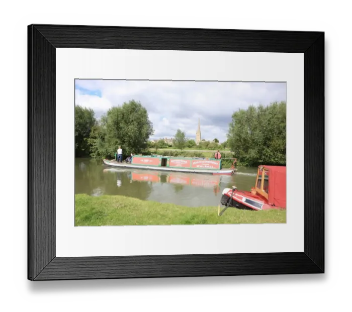 Framed Print : Lechlade. A canal boat on the upper Thames near St Lawrences Church at Framed Print : Lechlade. A canal boat on the upper Thames near St Lawrences Church at