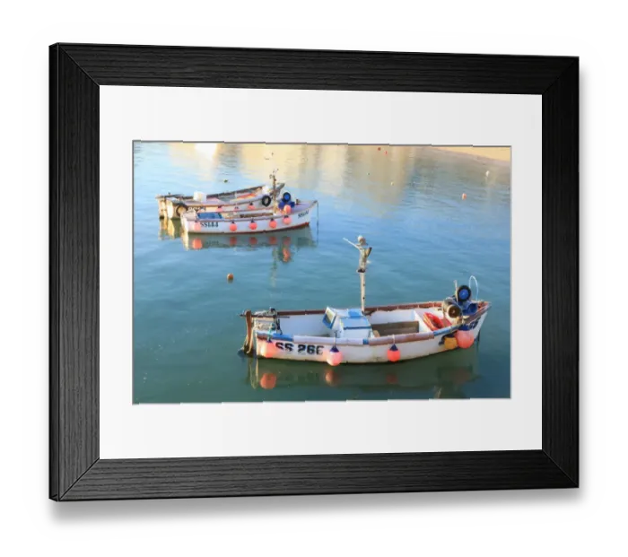 Framed Print : St Ives. Colourful fenders on the side of little open Fishing Boats lit Framed Print : St Ives. Colourful fenders on the side of little open Fishing Boats lit