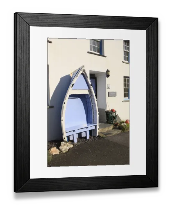 Framed Print : Boat Seat. A seat made from an old boat outside a cottage in the cornish Framed Print : Boat Seat. A seat made from an old boat outside a cottage in the cornish