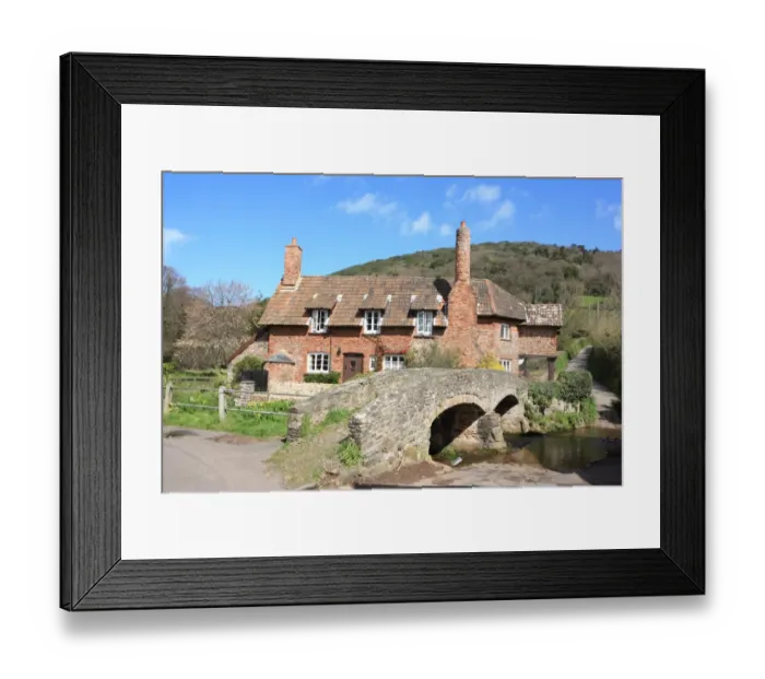 Framed Print : Allerford. Packhorse bridge and cottage in the village of Allerford Somerset Framed Print : Allerford. Packhorse bridge and cottage in the village of Allerford Somerset