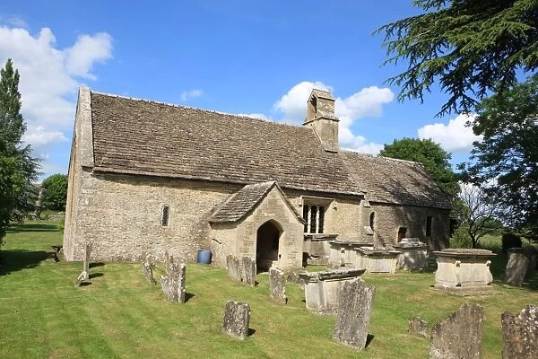 Ampney St Mary. The cotswold church with its spring flowers at Ampney St