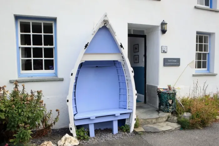 Framed Print : Boscastle. An old boat used as a seat outside a cottage in the North Cornish Framed Print : Boscastle. An old boat used as a seat outside a cottage in the North Cornish