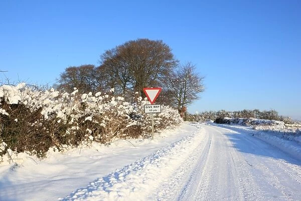 Burford. A road covered in snow on cold winters day near the cotswold town