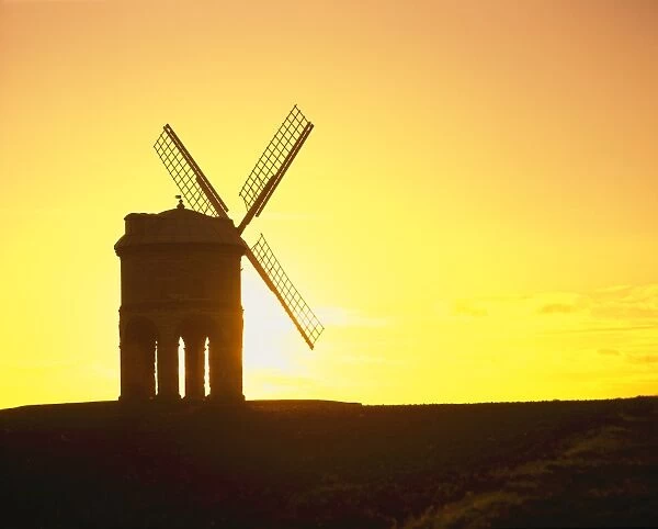 Chesterton. Sunset over the windmill on four stone arches at Chesterton in Warwickshire