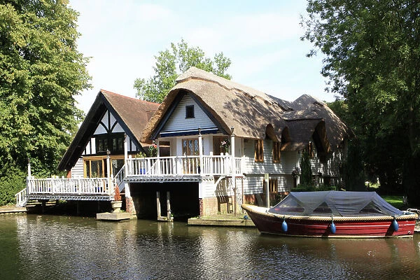 Goring on Thames. A picturesque thached Boathouse with a balcony beside