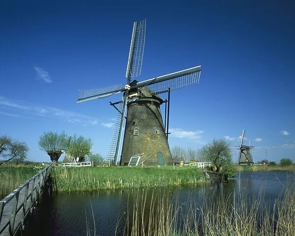 Kinderijik. The windmills and canals at Kinderijik in Holland on a Spring Day