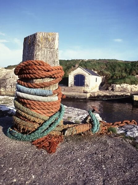 Northern Ireland. Ropes tied around a bollard on the quayside around the