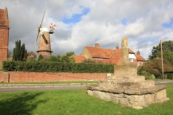Quainton. The 15th-century stone cross and Windmill built 1830 in the Buckinghamshire