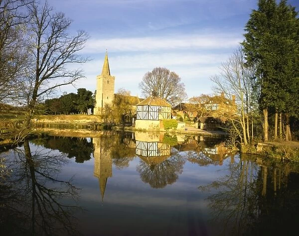 Staunton. The Timber Framed Dovecote and Church reflected in the fishing