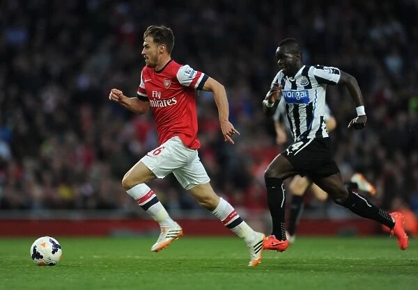 Ramsey Outpaces Tiote: Intense Rivalry in Arsenal vs. Newcastle United, Premier League, 2013 / 14