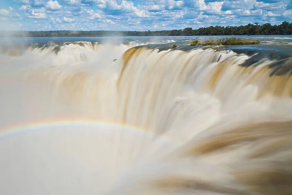 A rainbow over Devils Throat Overlook at Iguazu Falls
