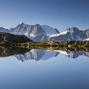 The Presanella group reflected into the Strino lakes, Val di Sole, Trentino-Alto Adige