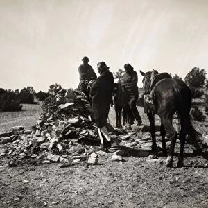NAVAJO RITUAL, c1904. Three Navajos with horses gathered before a ceremonial mound of rocks