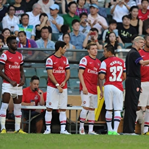 Arsenal FC: Arsene Wenger and Squad at Pre-Season Training in Hong Kong (2012) - Alex Song, Mikel Arteta, Thomas Eisfeld, Nico Yennaris, and Kyle Bartley
