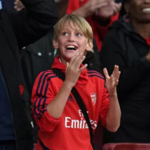 Arsenal's Triumphant Third Goal: A Sea of Celebrating Fans at Emirates Stadium