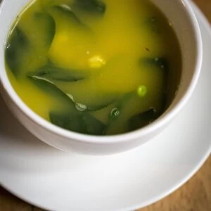 Light fresh soup made of lobster stock with saffron, prawns, peas and baby spinach