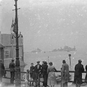 People gather on the river side to watch the Home Fleet on the Thames at Erith, London