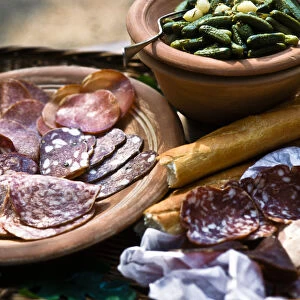 Selection of Italian cold, cired meats and salamis, with gherkins and French bread