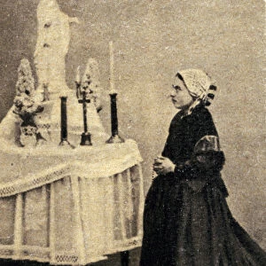Bernadette Soubirous kneeling before an altar with the Virgin