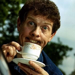 Phil Cool Comic pulling funny face holding cup and saucer Dbase