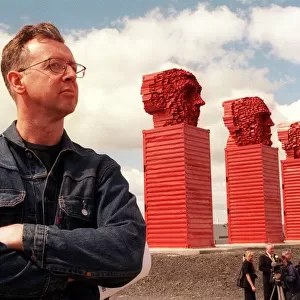 Sculptor David Mach June 1999 beside his Big Heids sculpture alongside the A8