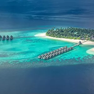 Amazing aerial landscape, luxury tropical resort or hotel with water villas and beautiful beach scenery. Perfect bird eyes view in Maldives, landscape
