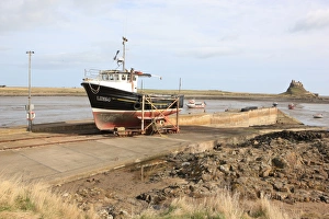 <b class=qtipBold><figcaption>Holy Island</figcaption></b><br>A fishing boat on the beach at Holy Island<br><em>© Paul Felix Photography Twelve Beacon Park Pelynt nr Looe Cornwall PL13 2PQ photos@paulfelix.co.uk 01503 221069</em> Holy Island