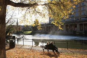 <b class=qtipBold><figcaption>Lovers of Bath</figcaption></b><br>Two lovers on a sunny morning in early winter beside the River Avon in the City of Bath with the leaves around there park bench<br><em>© Paul Felix Photography, Twelve Beacon Park, Pelynt near Looe Cornwall</em> Lovers of Bath