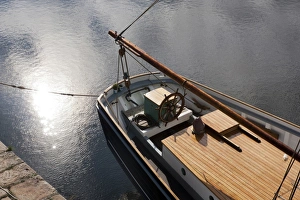 Pale autumn sunlight on the surface of water beside at tallship in the harbour at Charlestown Pale autumn sunlight on the surface of water beside at tallship in the harbour at Charlestown